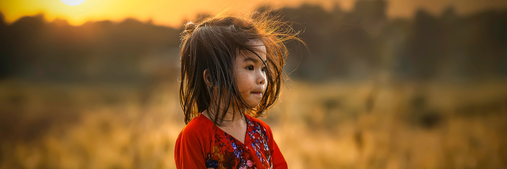 Photographer: Mi Pham
Agency: Unsplash A little girl on a field during golden hour.